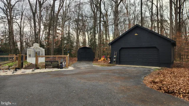 a backyard of a house with fireplace and iron fence
