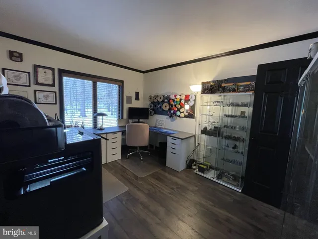 a utility room with wooden floor washer and dryer