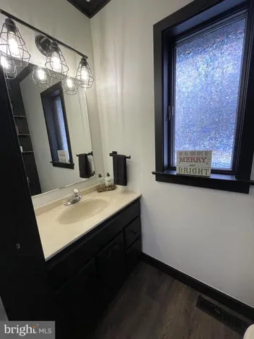 a bedroom with a bed dresser and a large window