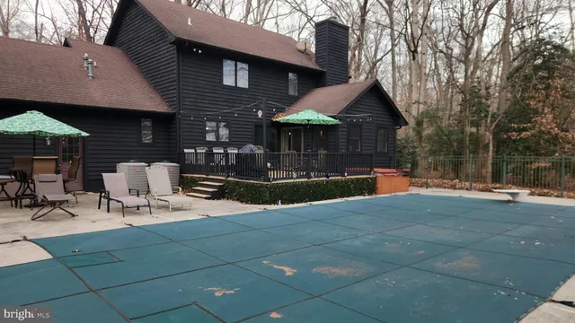 a view of a patio with table and chairs under an umbrella