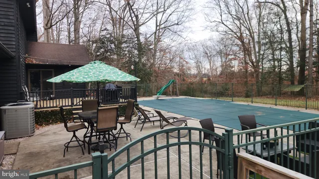 a view of backyard with seating and trees