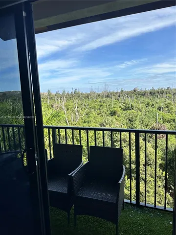 a bedroom with a bed a mirror and a window