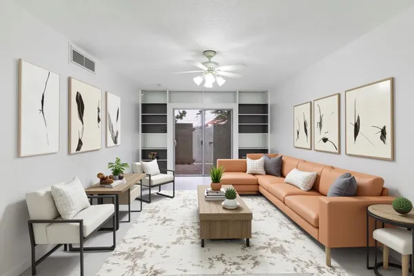 a living room with furniture ceiling fan and a rug