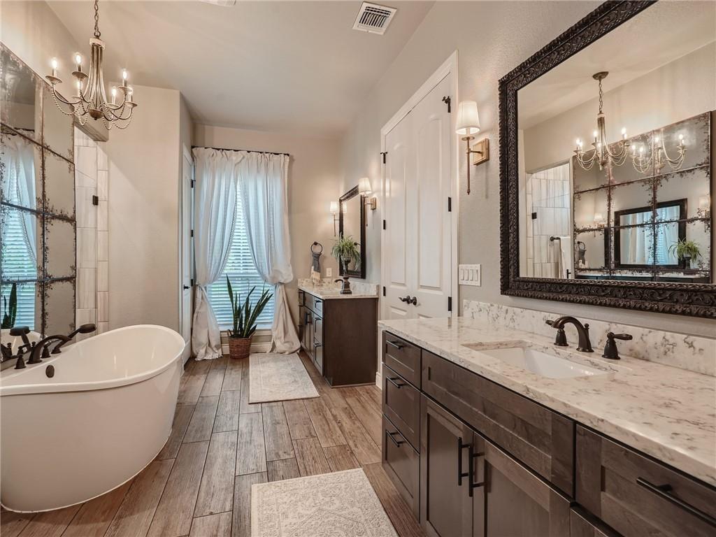 132 Huerta Road Florence, TX 76527 - Photo 16 of 40 Indulge in this opulent primary bathroom, offering a freestanding tub and dual vanities.
