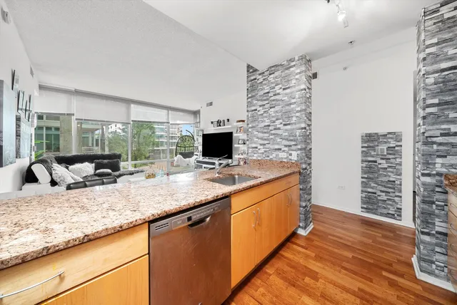 a kitchen with granite countertop a sink and a stove