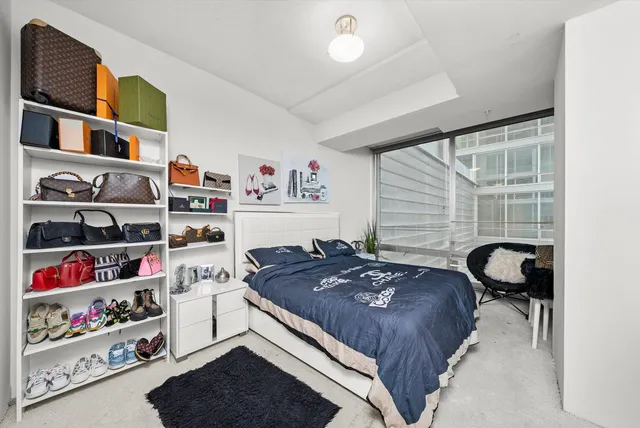 a bed room with a bed and a window