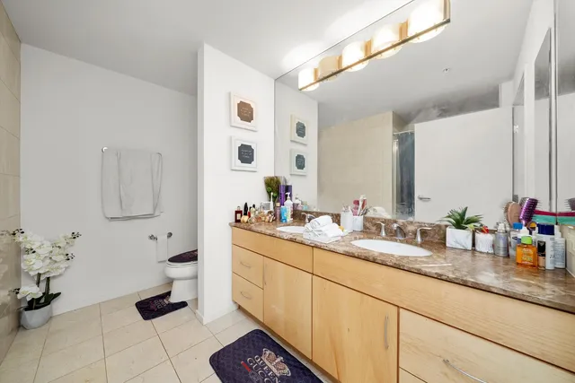 a bathroom with a sink a toilet and mirror