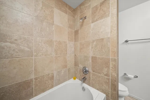 a bathroom with a bathtub and shower