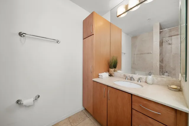 a bathroom with a double vanity sink and a mirror
