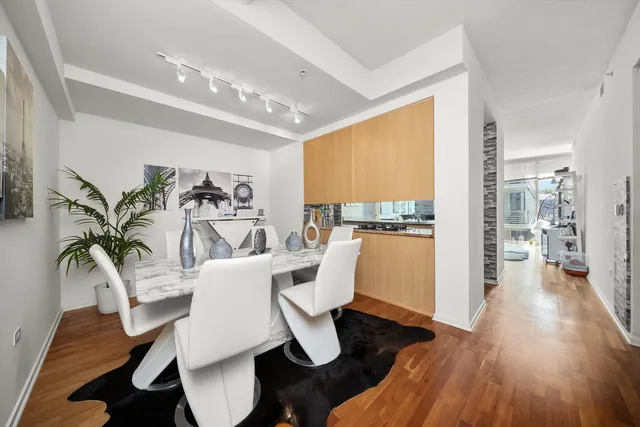 a dining room with furniture a rug and wooden floor