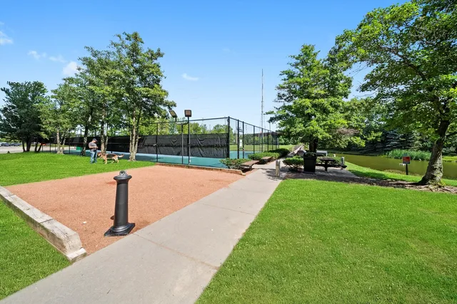 a park with large trees and a childrens park