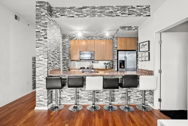 a view of a kitchen with dining room and wooden floor