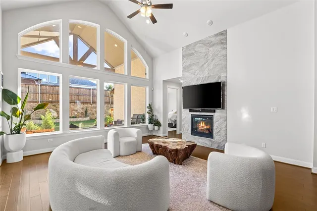 a kitchen with stainless steel appliances kitchen island granite countertop a refrigerator a stove top oven a sink dishwasher and white cabinets with wooden floor