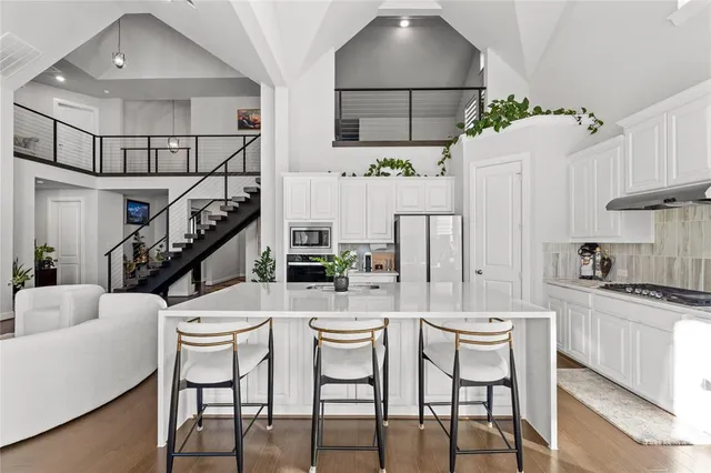 a dining room with furniture a chandelier and wooden floor