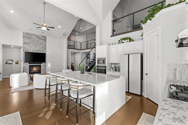 a bed sitting in a spacious bedroom next to a window