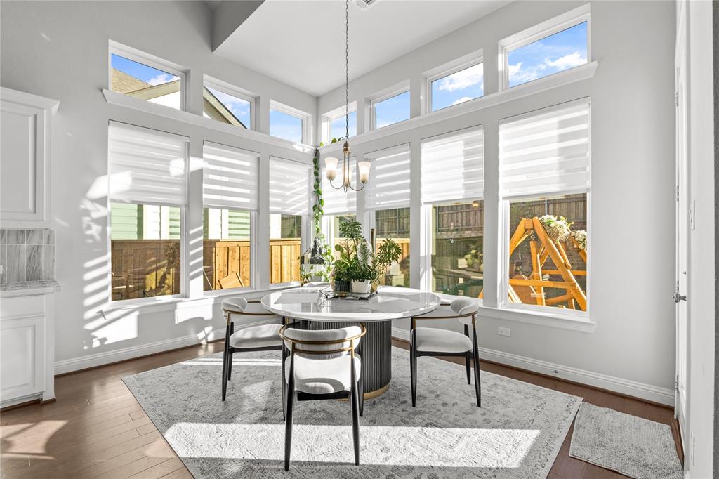 3516 Ithaca Street Corinth, TX 76208 - Photo 18 of 40 a dining room with furniture a chandelier and wooden floor