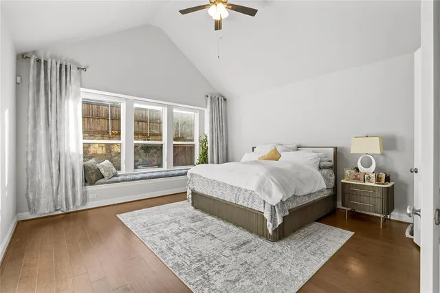 a bathroom with a granite countertop sink a toilet a mirror a bathtub and shower