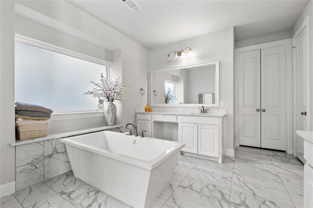3516 Ithaca Street Corinth, TX 76208 - Photo 20 of 40 a spacious bathroom with a bathtub sink and mirror