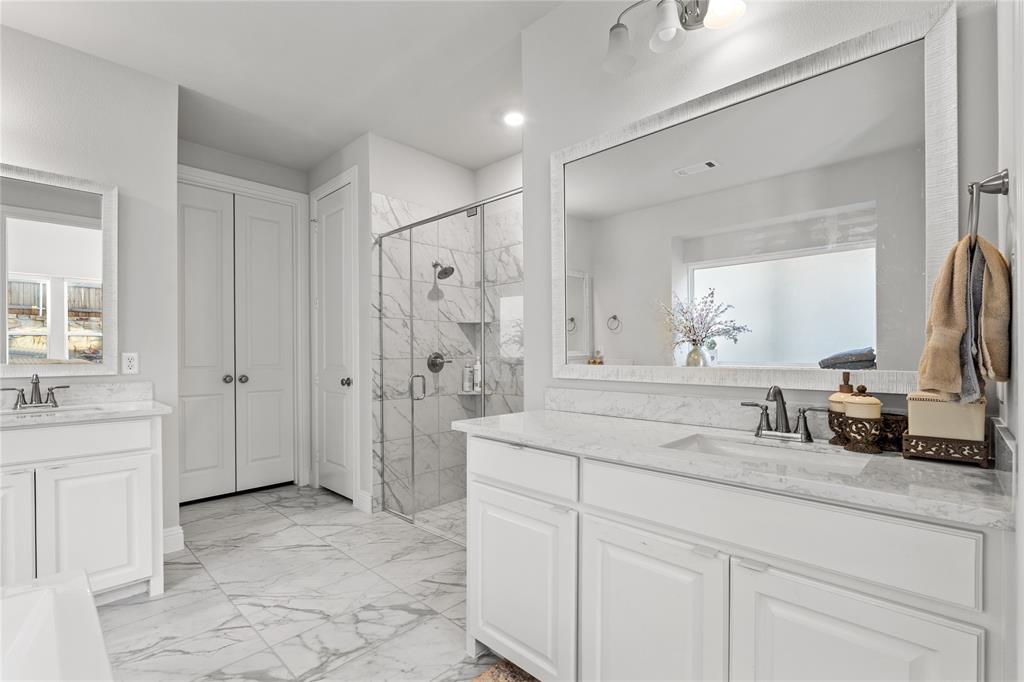 3516 Ithaca Street Corinth, TX 76208 - Photo 21 of 40 a spacious bathroom with a shower sink and mirror