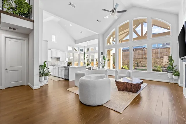 a living room with furniture and wooden floor