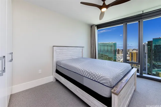 a bed sitting in a bedroom next to a window