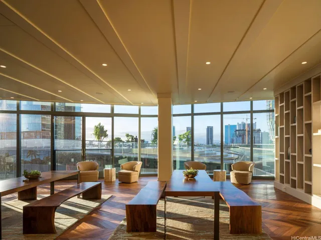 a living room with furniture and floor to ceiling windows