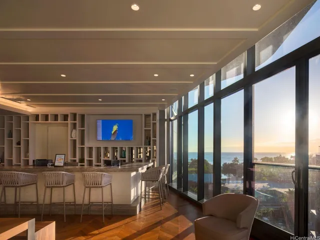 a living room with large windows and a table