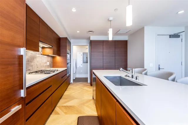 a large kitchen with kitchen island a large counter space