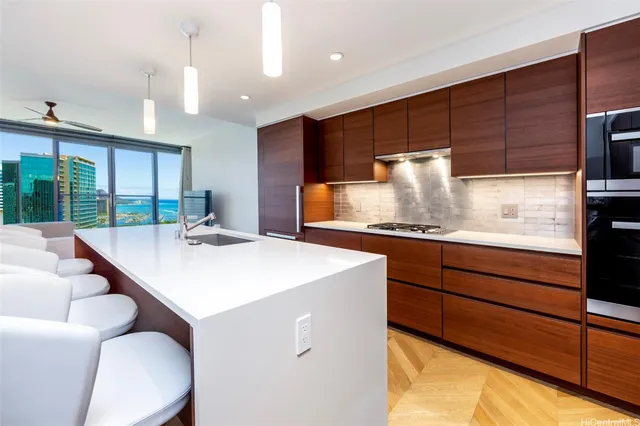 a kitchen with kitchen island granite countertop a sink a counter and chairs