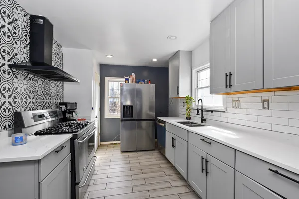 a kitchen with a sink stove and refrigerator