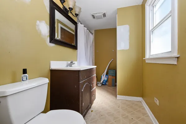 a bathroom with a sink a toilet and a mirror