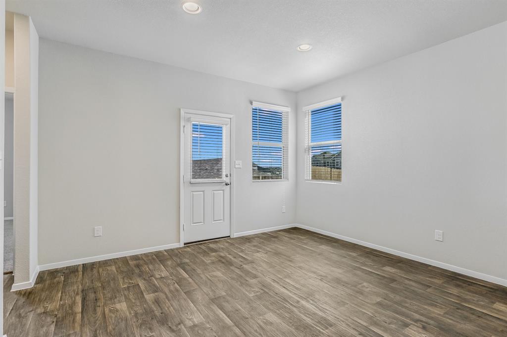2808 Totley Road Manor, TX 78653 - Photo 7 of 21 Open-concept room featuring wood-finish flooring, white walls, and recessed lighting