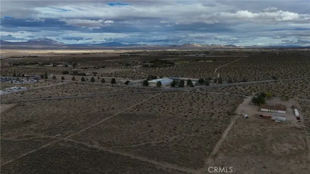 a view of a dry yard with wooden floor and city view