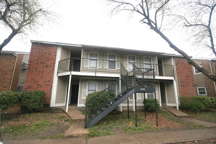 Two-story apartment building featuring brick and siding exterior construction