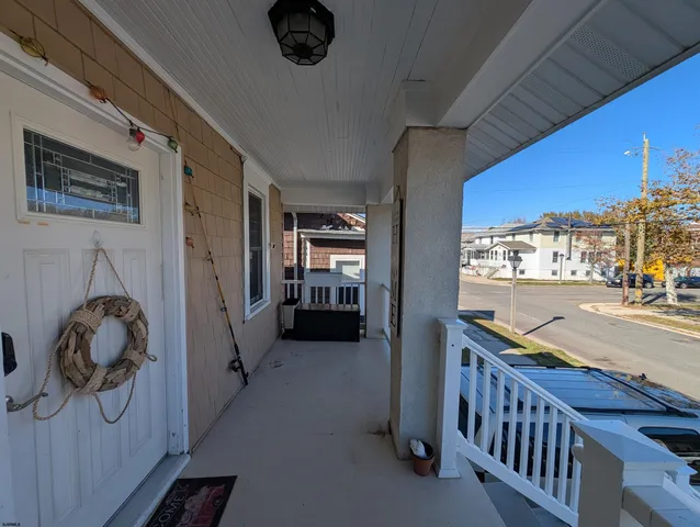 a view of hallway with furniture and a gate