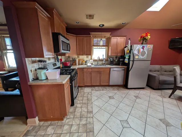 a view of a dining room with furniture and chandelier