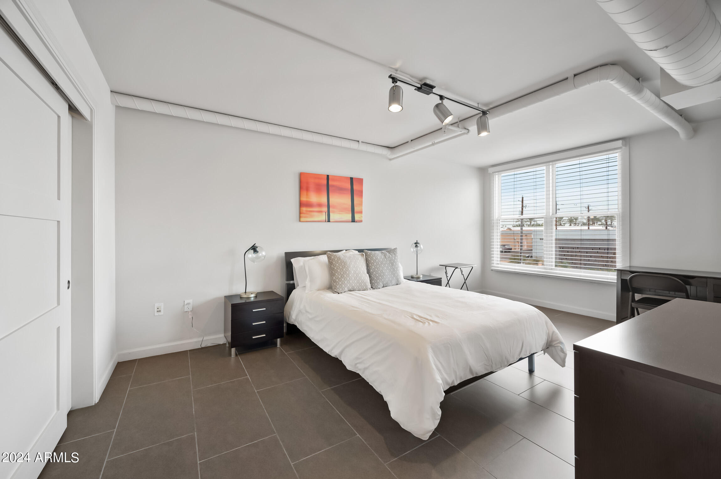 535 West Thomas Road, Unit 212 Phoenix, AZ 85013 - Photo 17 of 18 a bedroom with a bed and window