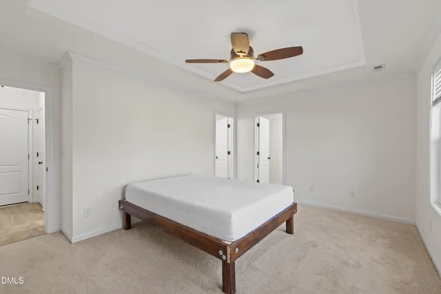 a room with a bed and a chandelier