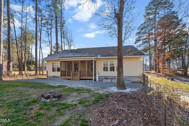a view of a house with a yard and sitting area