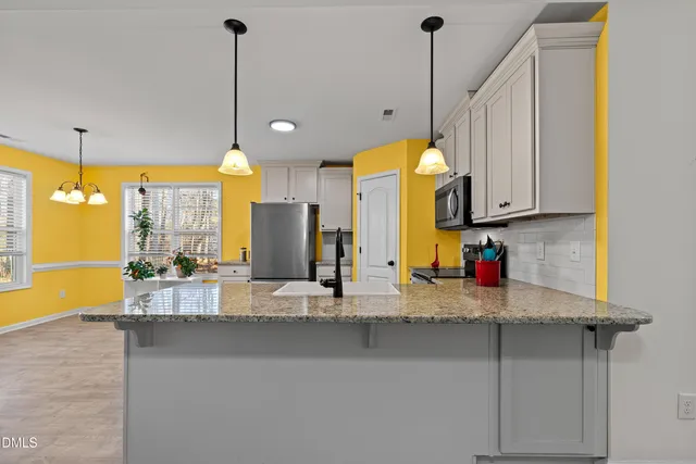 a kitchen with counter top space and a chandelier
