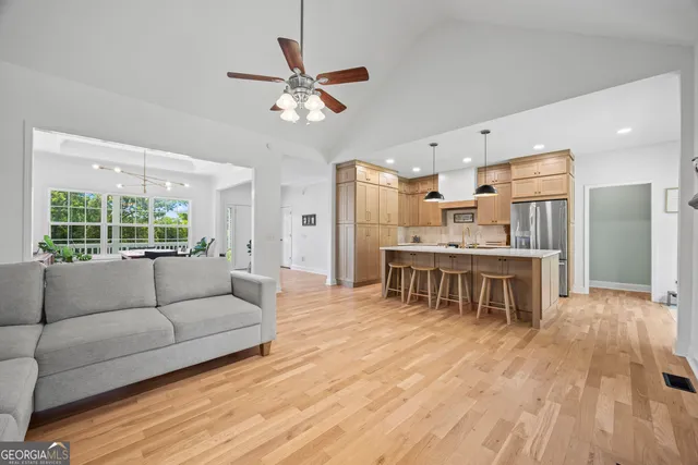 a kitchen with stainless steel appliances granite countertop a sink a stove and a refrigerator