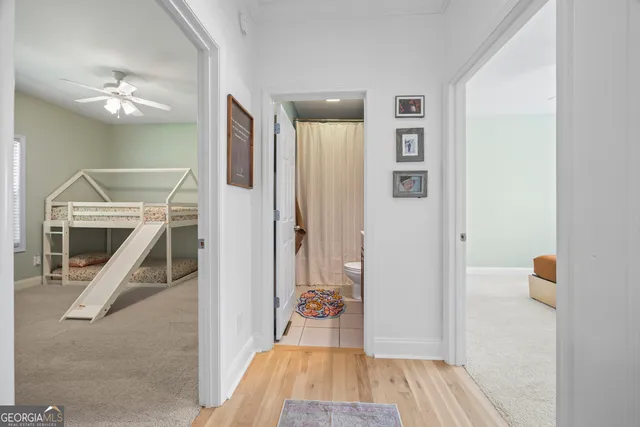 a spacious bathroom with a tub sink and mirror
