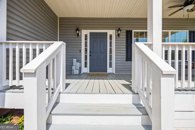 a kitchen with stainless steel appliances granite countertop a refrigerator stove and white cabinets