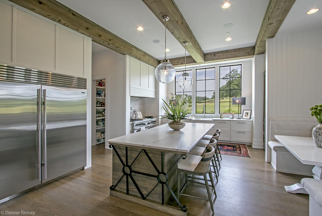 5747 Garrison Road Franklin, TN 37064 - Photo 8 of 30 a kitchen with stainless steel appliances granite countertop table chairs refrigerator and microwave