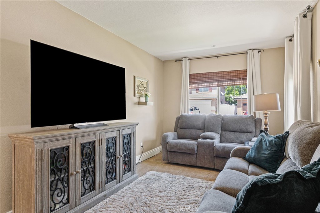 7615 Canberra Way Riverside, CA 92508 - Photo 13 of 37 a living room with furniture and a flat screen tv