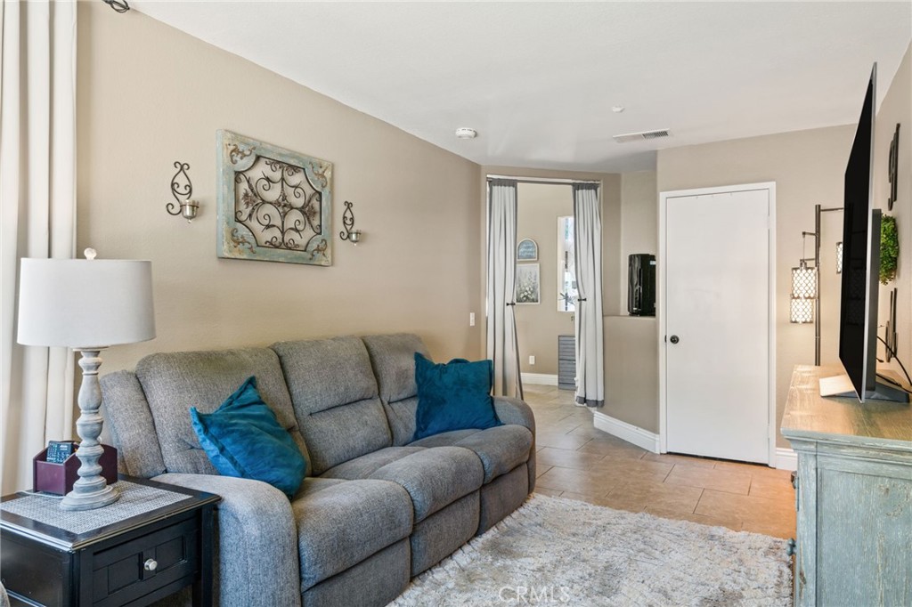 7615 Canberra Way Riverside, CA 92508 - Photo 14 of 37 a living room with furniture and a couch