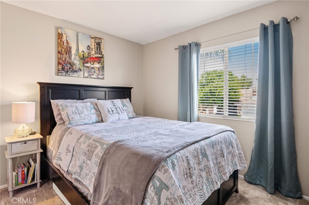 7615 Canberra Way Riverside, CA 92508 - Photo 19 of 37 a bed sitting in a bedroom next to a window