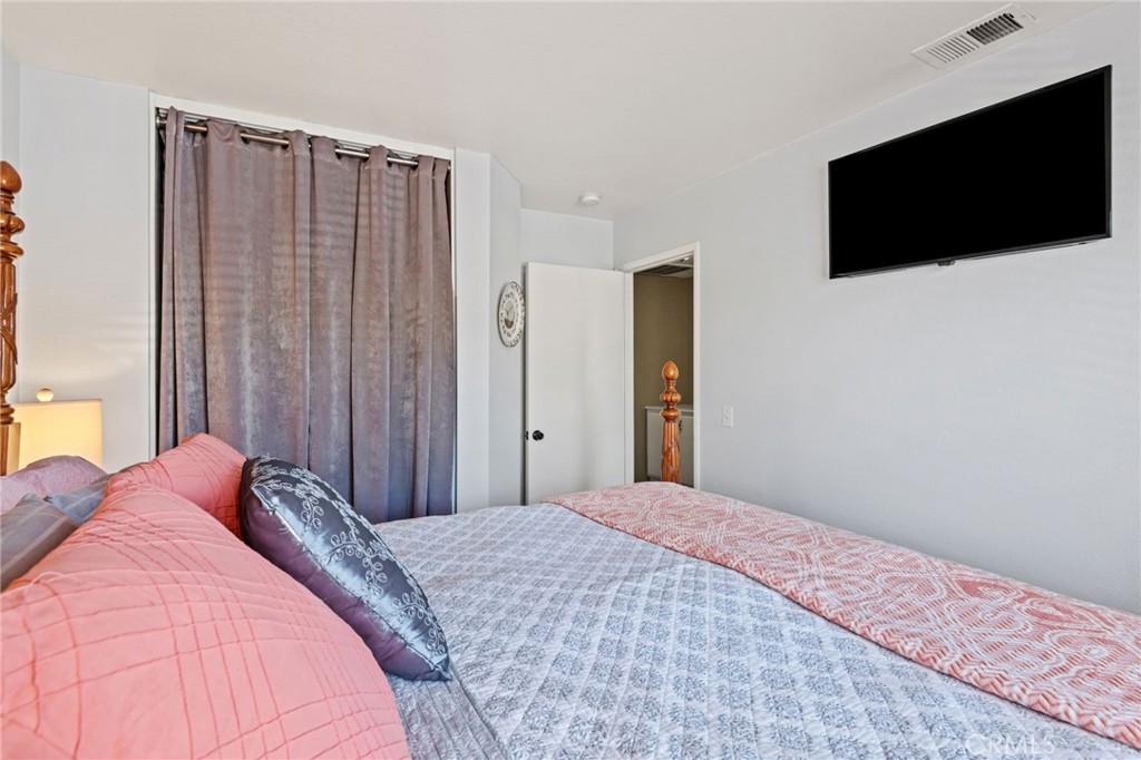7615 Canberra Way Riverside, CA 92508 - Photo 23 of 37 a bedroom with a bed and a flat screen tv