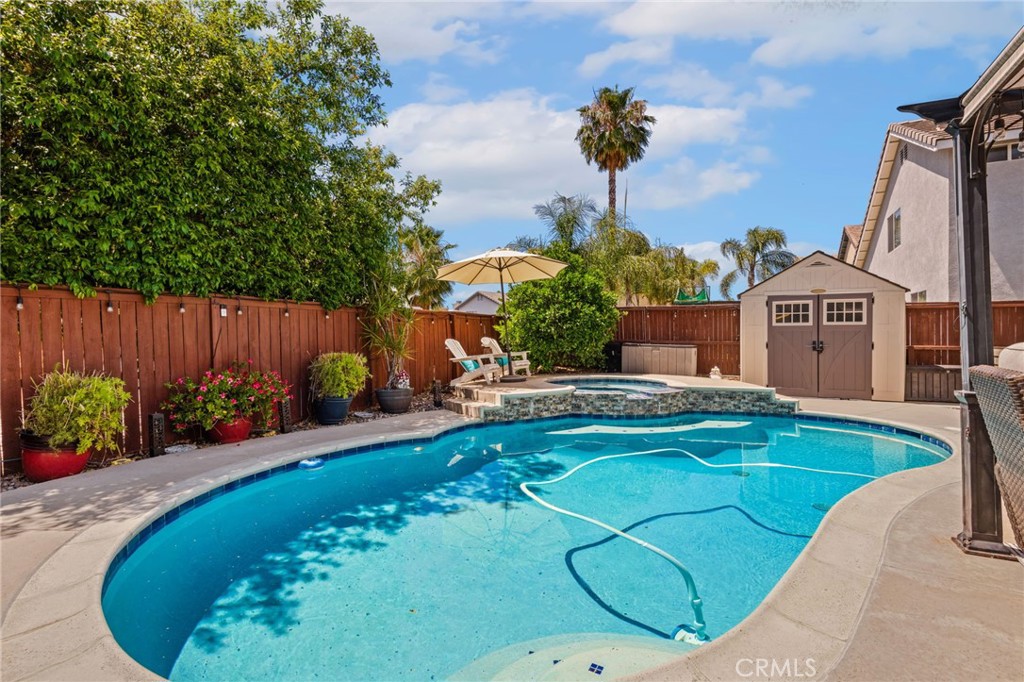 7615 Canberra Way Riverside, CA 92508 - Photo 28 of 37 a view of a swimming pool with a garden
