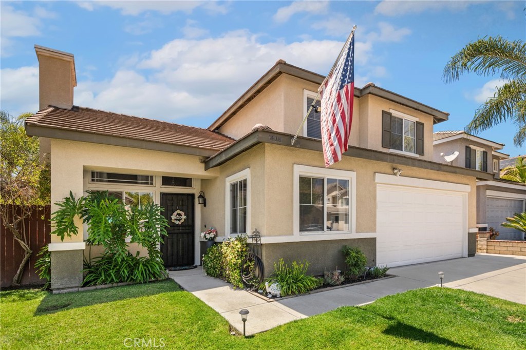7615 Canberra Way Riverside, CA 92508 - Photo 3 of 37 a view of a house with brick walls and a yard with plants